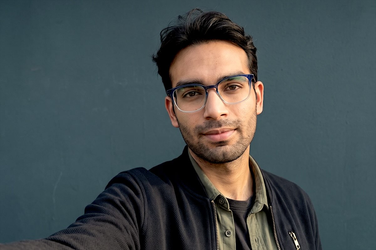Abhishek Kumar taking a selfie against a blue wall
