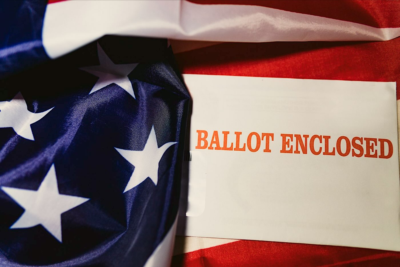 A ballot envelope resting on a flag